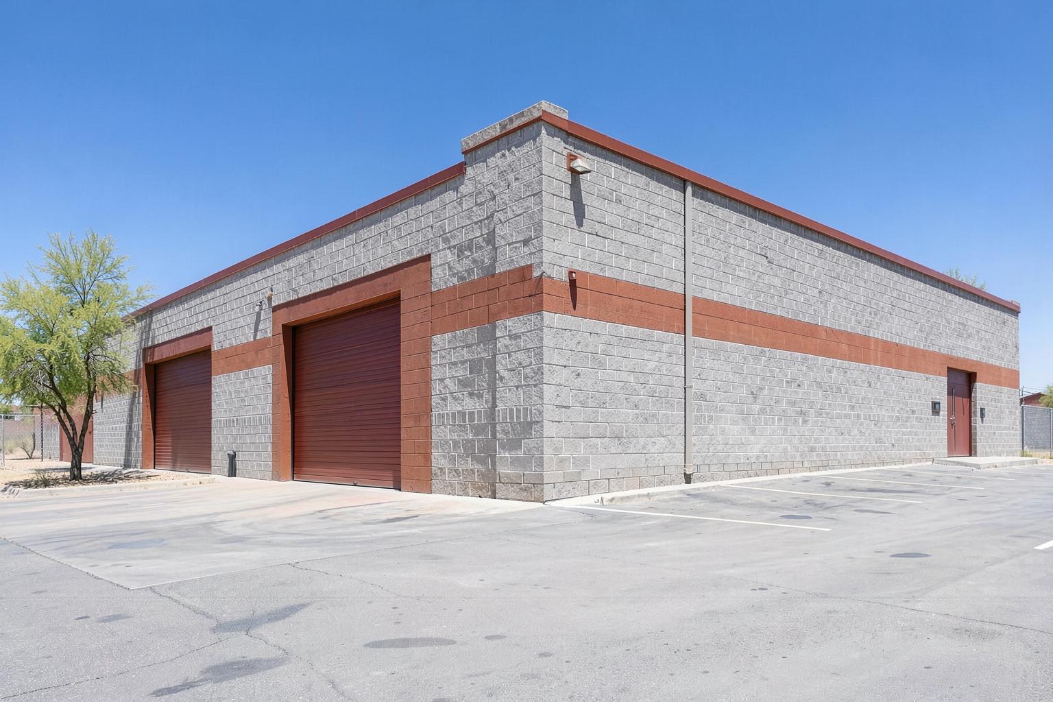 Cream stucco warehouse with open shop doors in the Sonoran desert in Scottsdale, Arizona